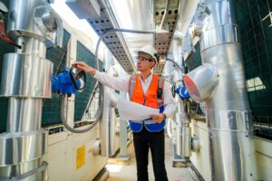 Industrial factory ceiling with ventilation system and lights. Ventilation ducts.